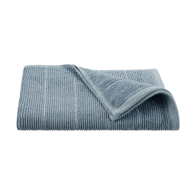 Soft blue towel with textured slub stripes, folded with one corner turned down.