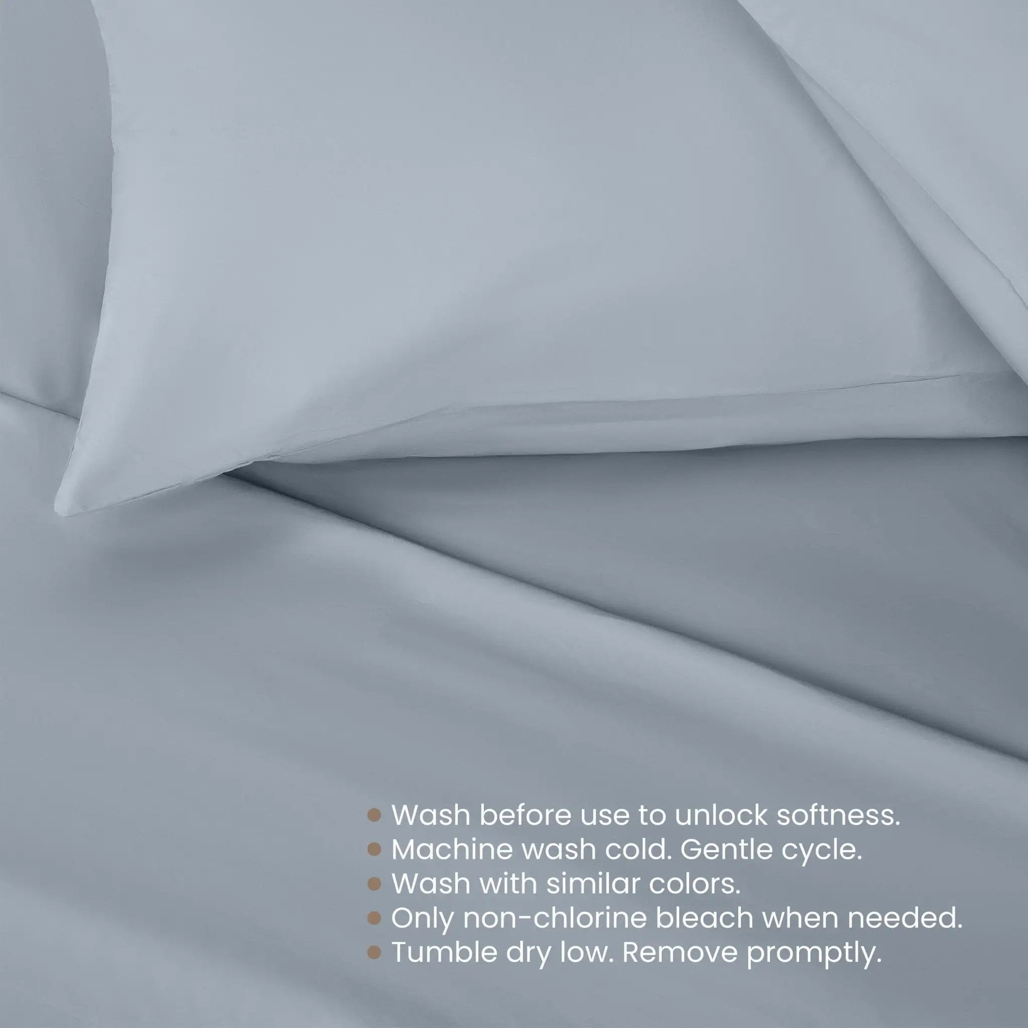 Light blue bedding fabric with a pillowcase and a list of care instructions printed at the bottom right.