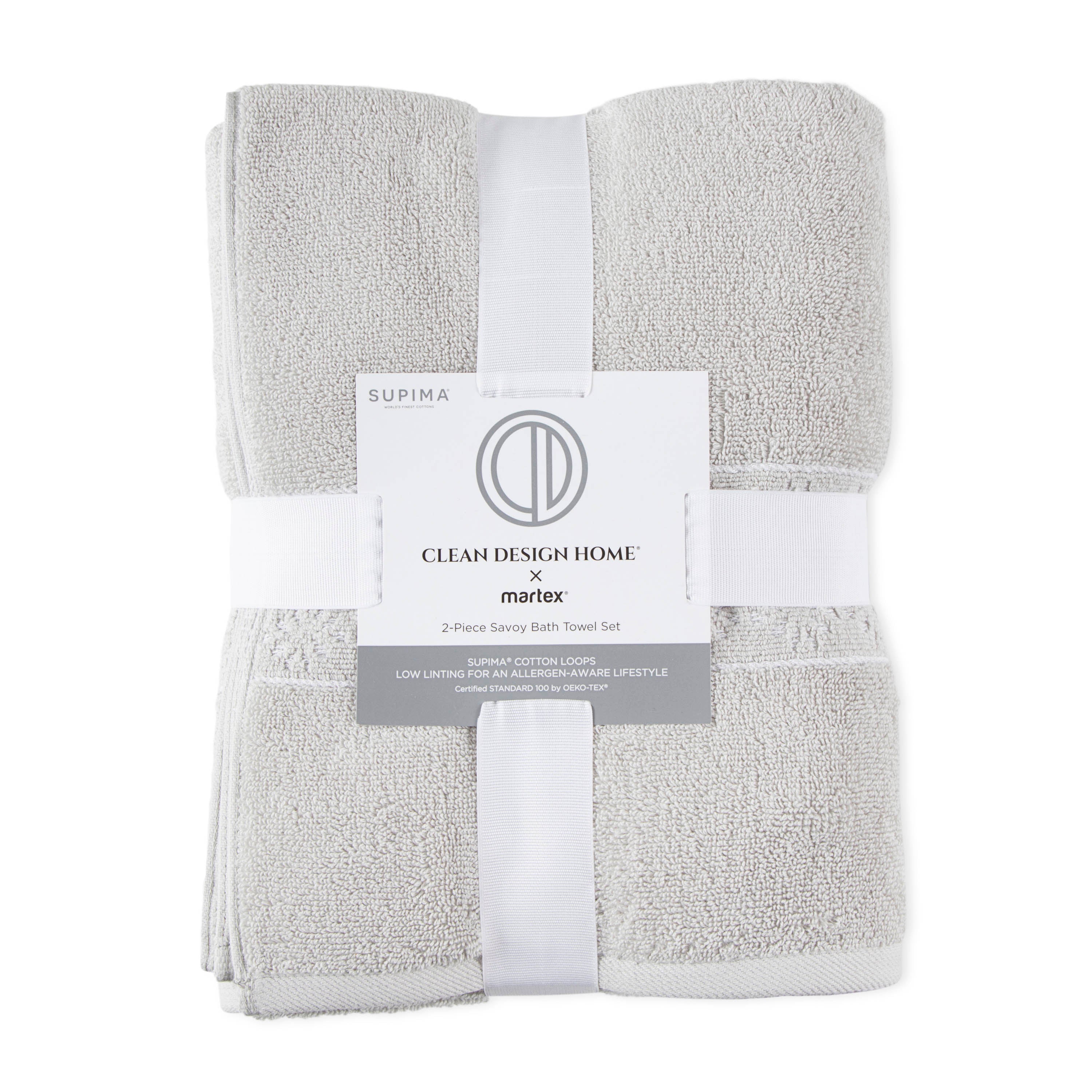 Two gray towels neatly folded and secured with a white band featuring product information.