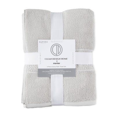 Two gray towels neatly folded and secured with a white band featuring product information.