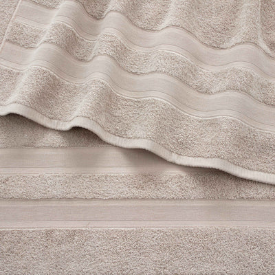 Solid beige towels with textured stripes, arranged in a layered fashion.
