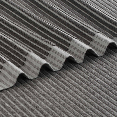 Gray towels with a sculpted stripe pattern, featuring alternating textured and smooth sections.