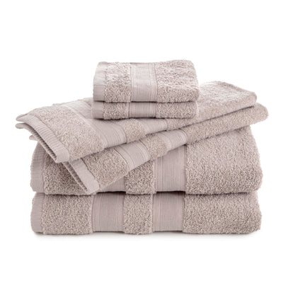Six solid beige towels stacked, including two bath towels, two hand towels, and two washcloths.