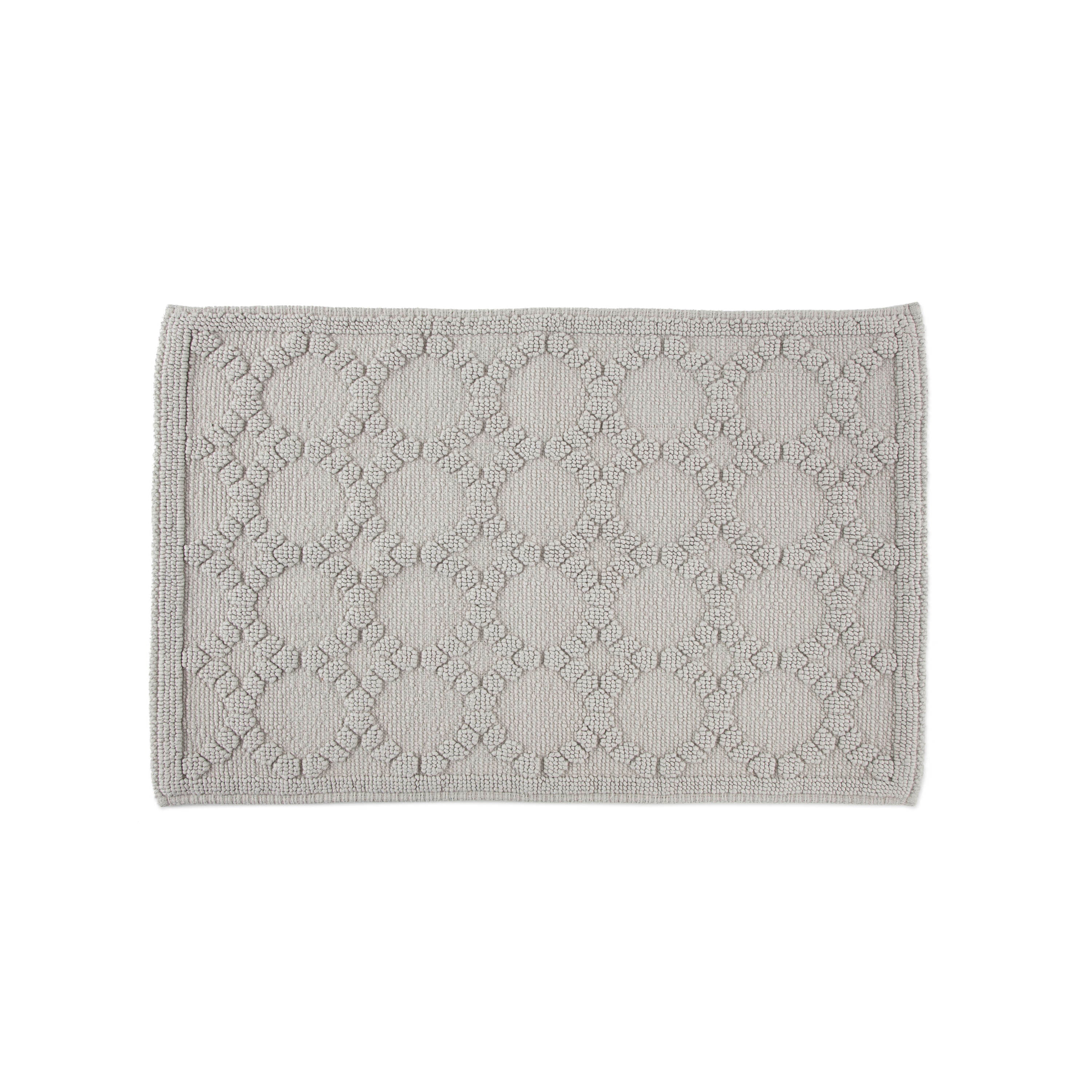 Gray bath rug with a textured pattern of circles and floral designs, featuring a bordered edge.