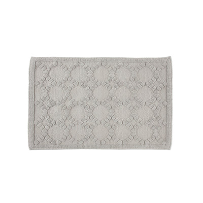 Gray bath rug with a textured pattern of circles and floral designs, featuring a bordered edge.