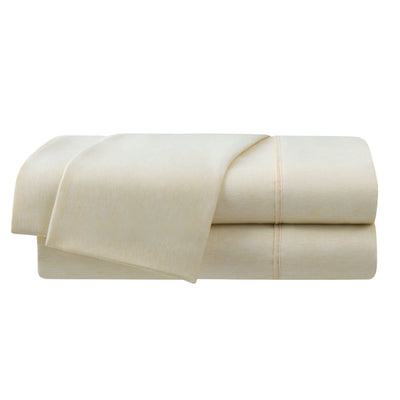 Light yellow herringbone sheet set with a smooth texture, featuring folded edges and visible stitching.