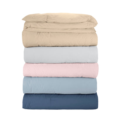 Stack of six duvet covers in beige, light gray, pink, light blue, and dark blue colors.