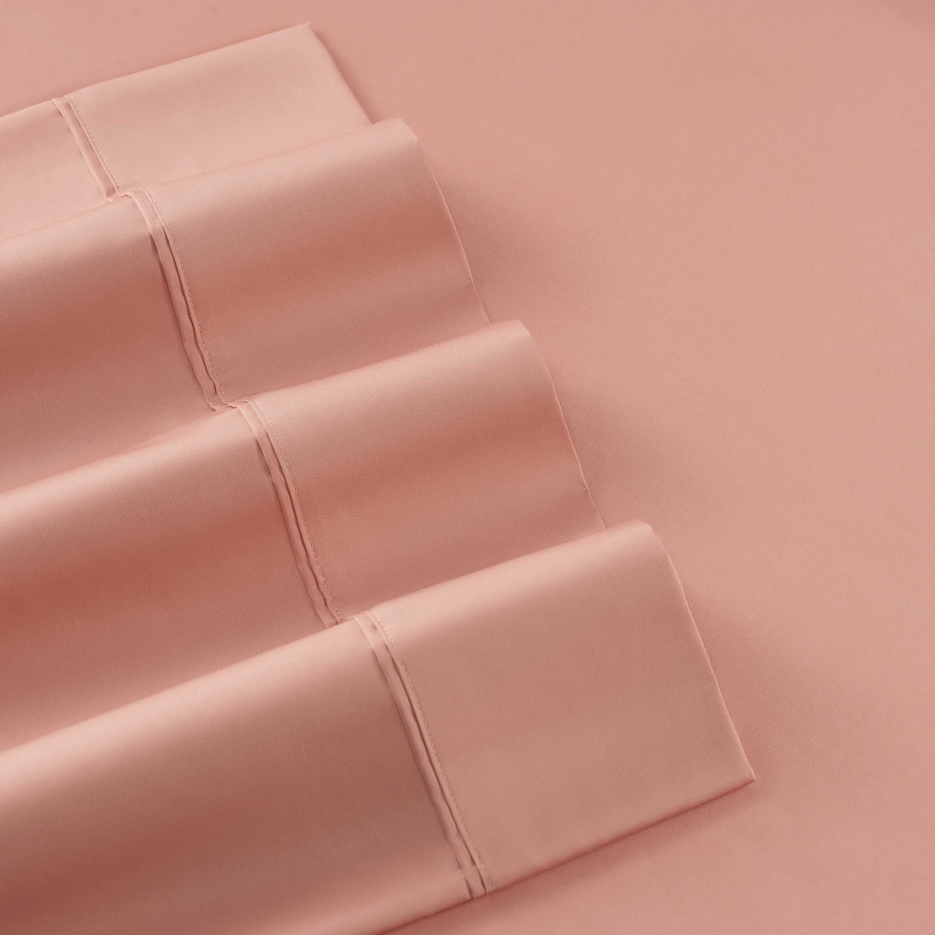 Solid cotton and Tencel sheet set in a soft peach color with visible stitching details.