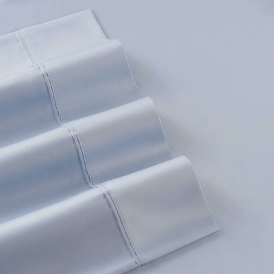 Solid light blue cotton and Tencel sheet set with smooth, folded edges.