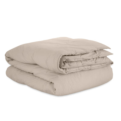 Beige duvet set folded neatly, featuring a smooth, percale fabric texture.