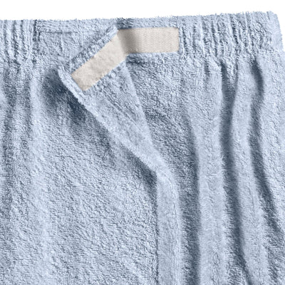 Light blue shower wrap with a textured surface and a velcro closure at the top.