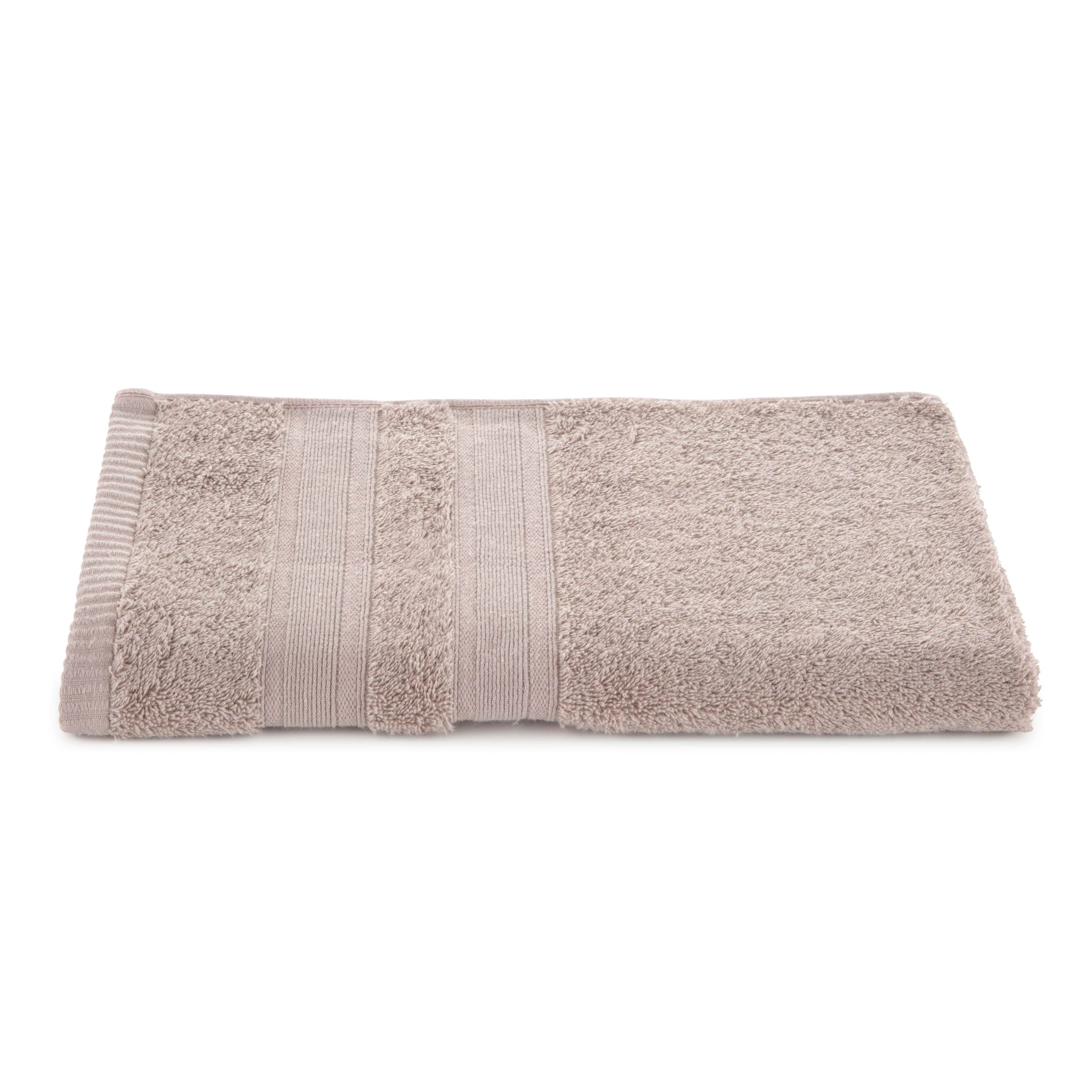 Solid beige towel with textured stripes and low lint design, folded neatly on a white background.