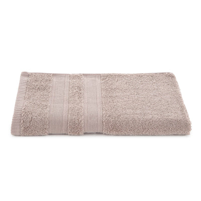 Solid beige towel with textured stripes and low lint design, folded neatly on a white background.