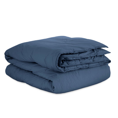 Navy blue duvet set folded neatly, featuring a smooth, percale texture.