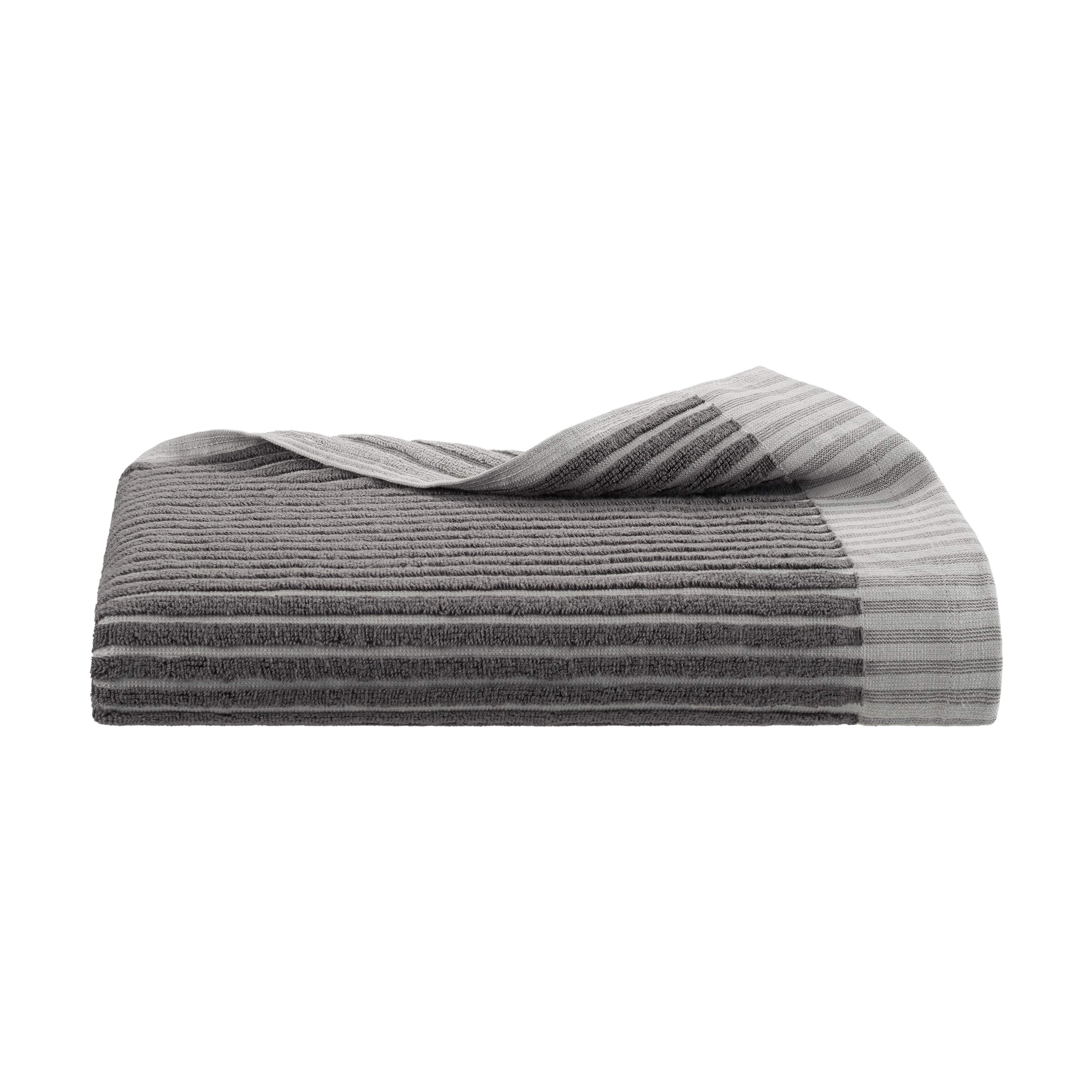 Gray towel with a sculpted stripe design, folded with one corner slightly draped over.