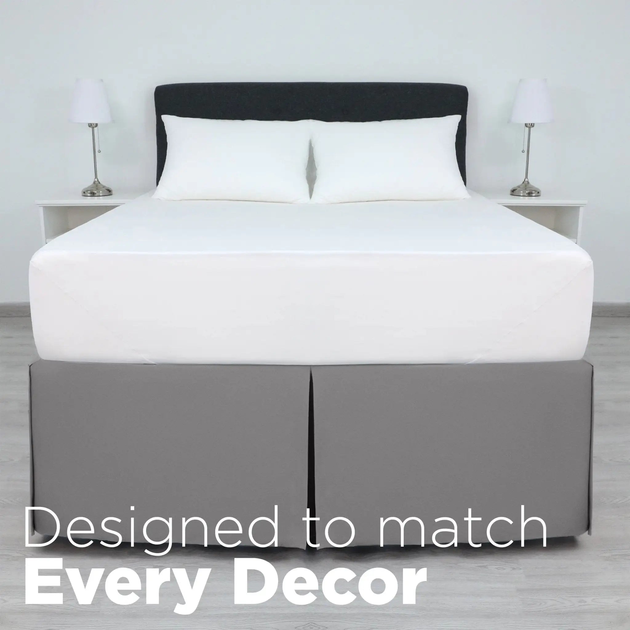 A bed dressed in white bedding, including a white mattress, white pillows, and a grey bed skirt.