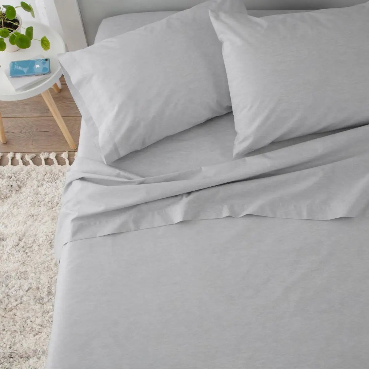 Gray bedding set on a bed.