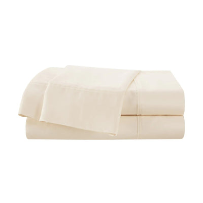 A folded stack of ivory-colored bedding, likely a sheet set, photographed against a solid white background.
