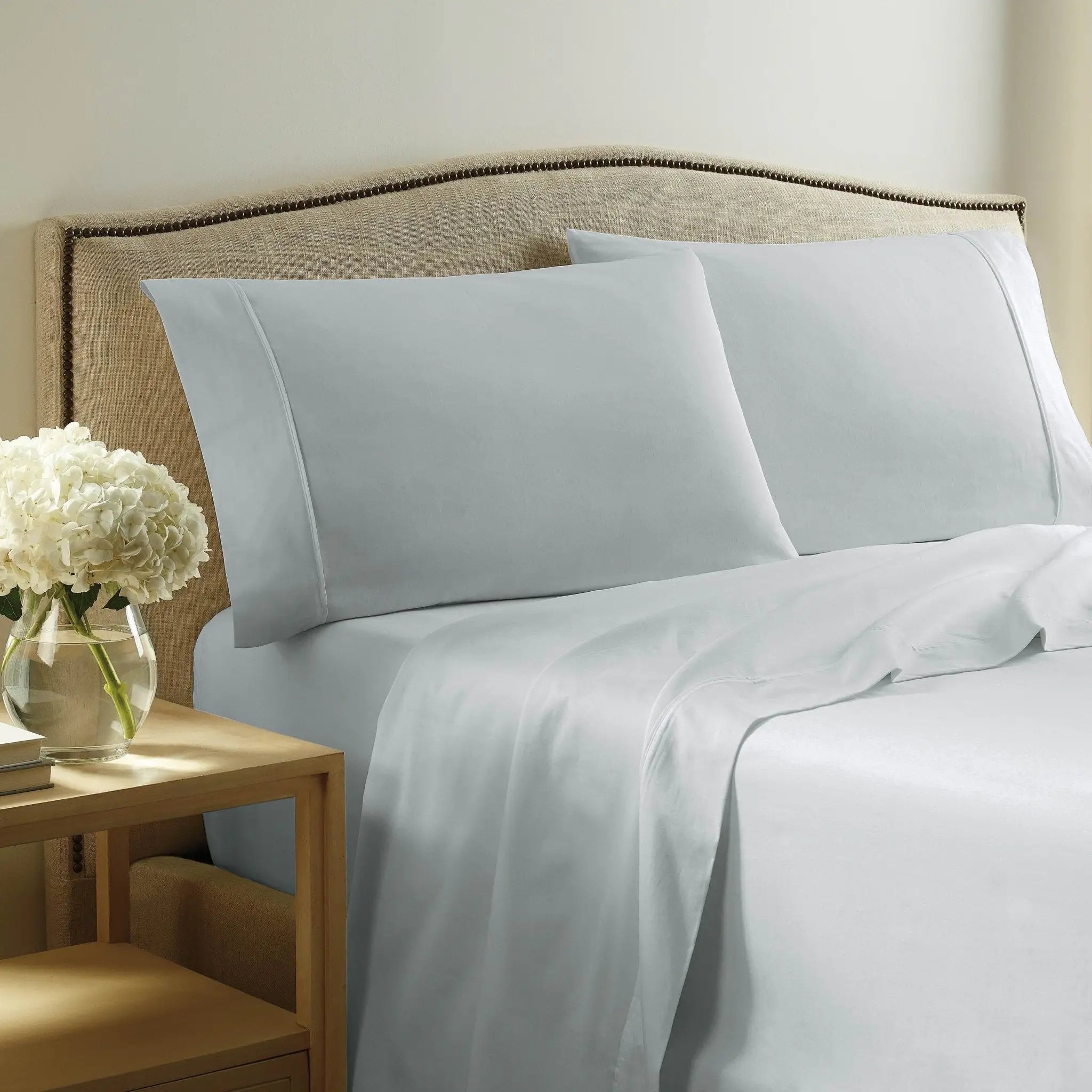 Gray bedding set on a bed.