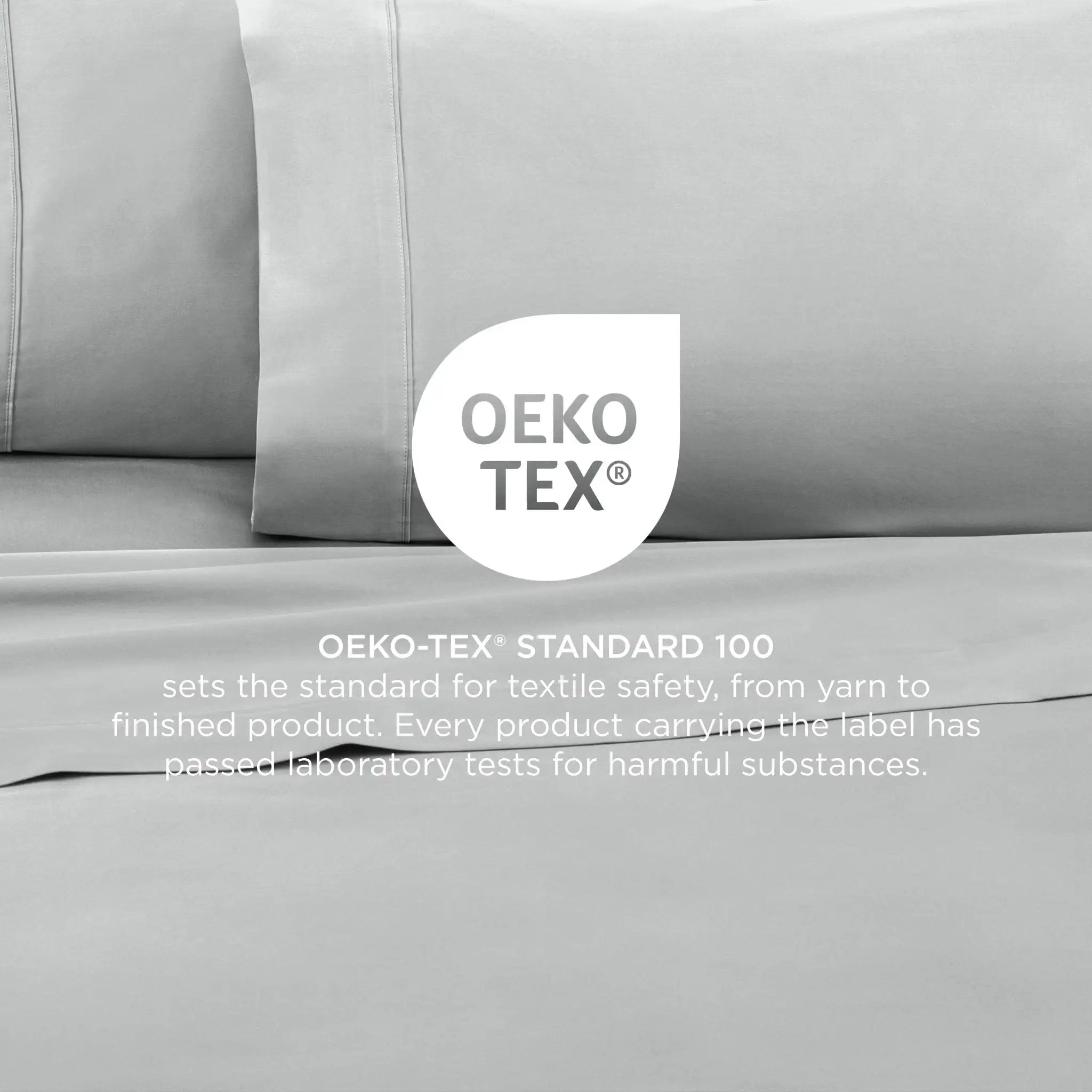Grey bedding set with OEKO-TEX label on a neutral background