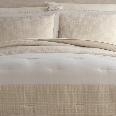 Neatly made bed with beige patterned bedding