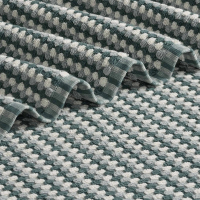 A close-up of a slate bath towel with a repeating geometric pattern.