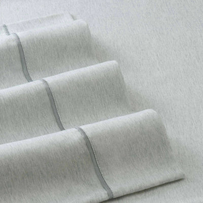 Close-up of light gray fabric with a subtle pattern on a matching background