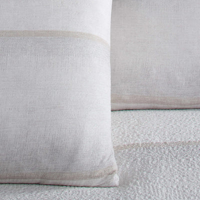Close-up of two textured pillow shams on a matching fabric background
