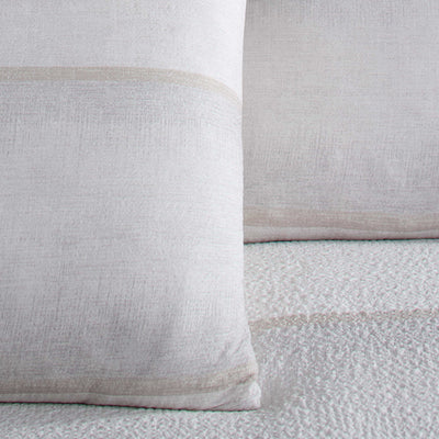 Close-up of two textured pillow shams on a matching fabric background