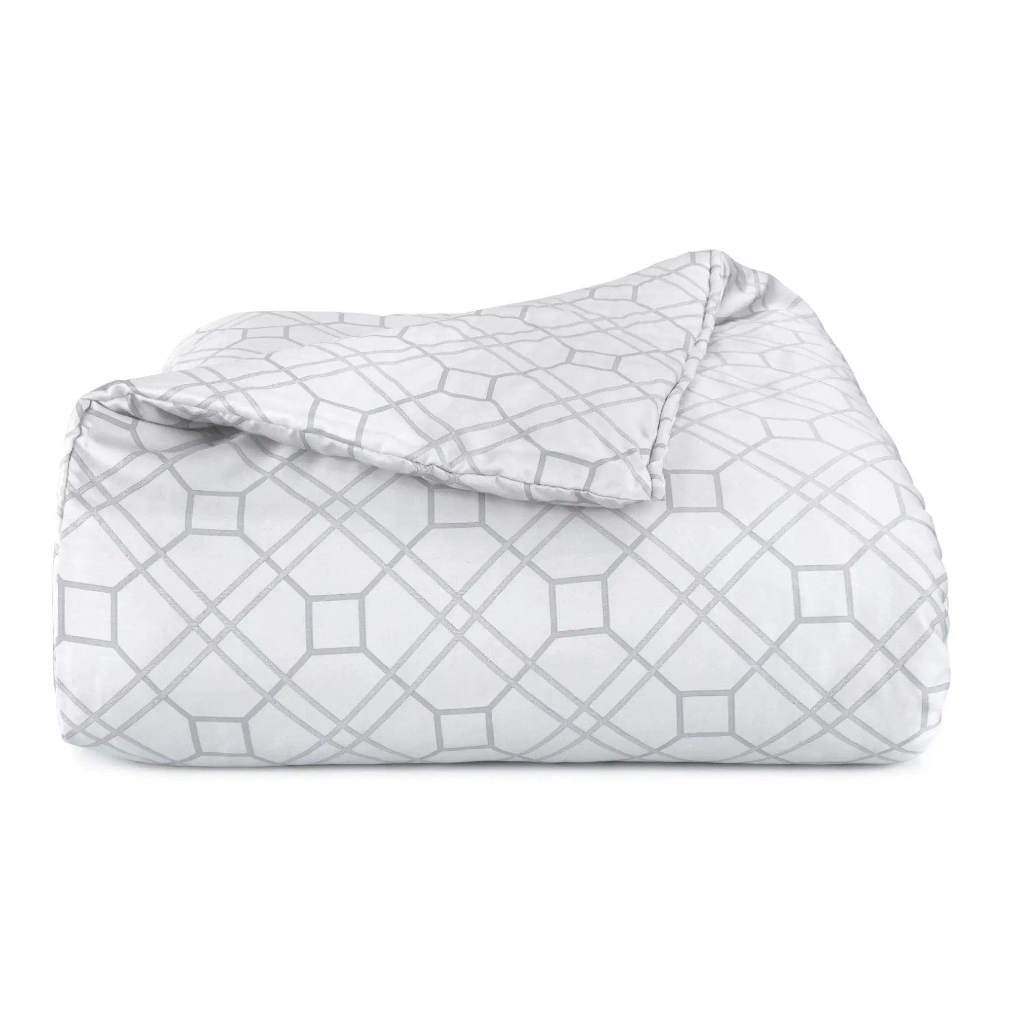 Folded comforter with geometric pattern on a white background