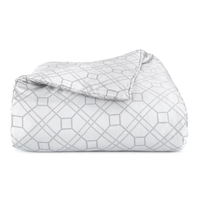 Folded comforter with geometric pattern on a white background