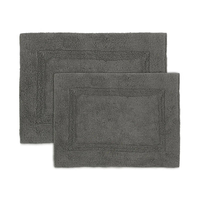Two dark gray rectangular bath rugs with raised border detailing, shown overlapping on a plain white background.