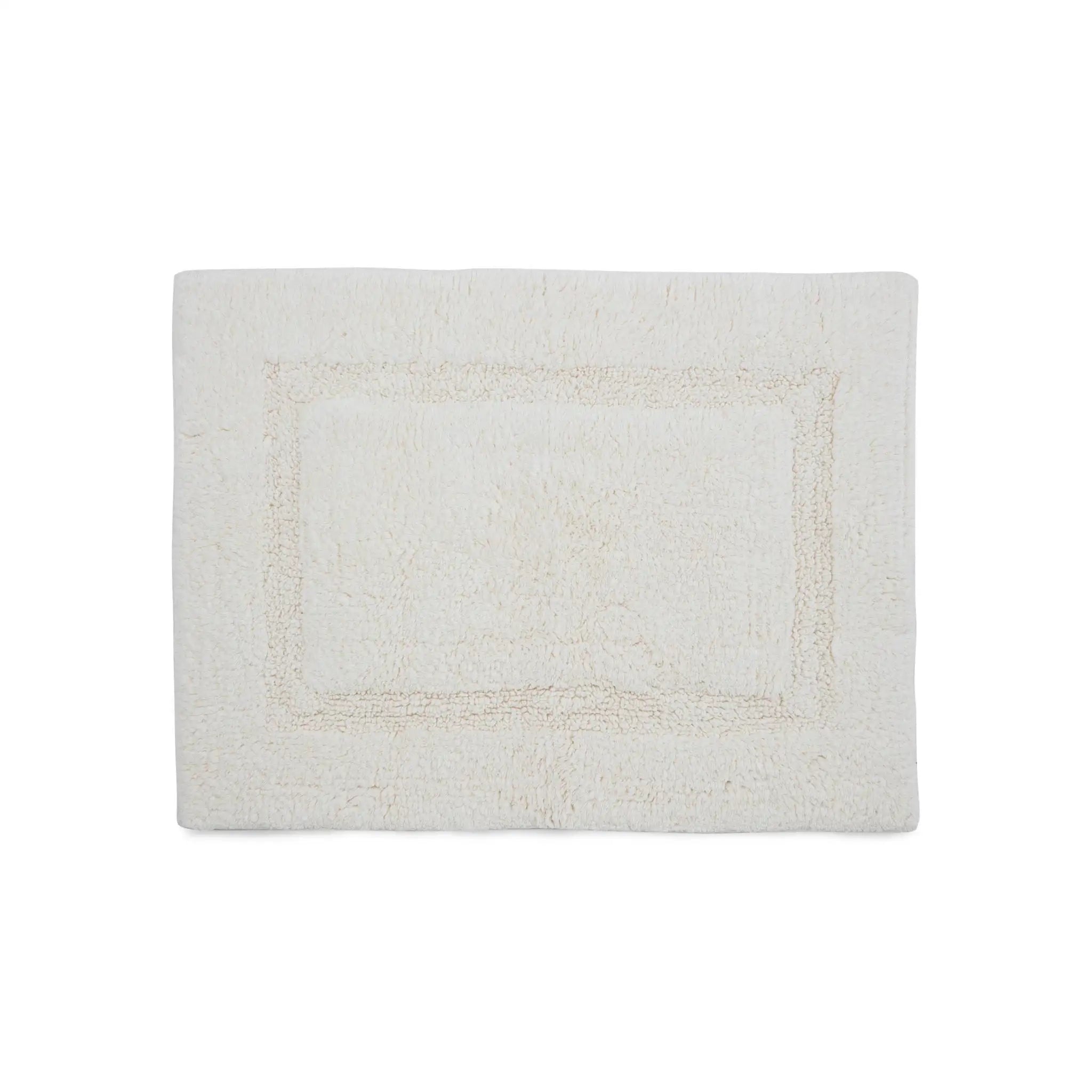 A rectangular bath rug with a raised border design, shown flat against a solid white background.