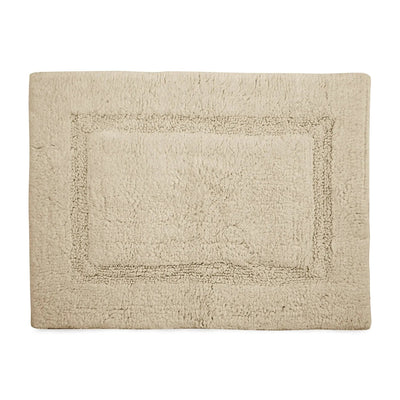 A rectangular cream bath rug with a raised border design, shown flat against a solid white background.