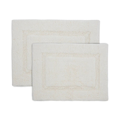 Two white bath rugs on a white background