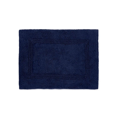A rectangular estate blue bath rug with a raised border, shown flat against a solid white background.