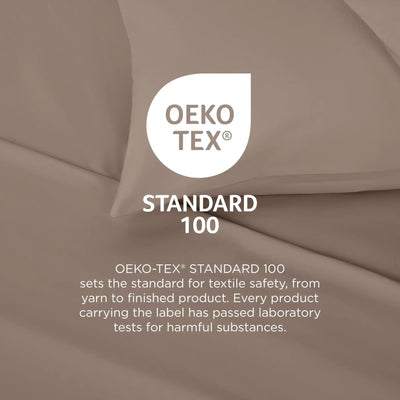 A close-up of draped taupe-beige fabric with a white OEKO-TEX Standard 100 logo and explanatory text overlaid in the center.