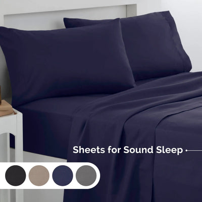 Navy bed sheets and pillows on a bed with color swatches below.