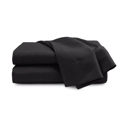 Folded black bed sheets on a white background
