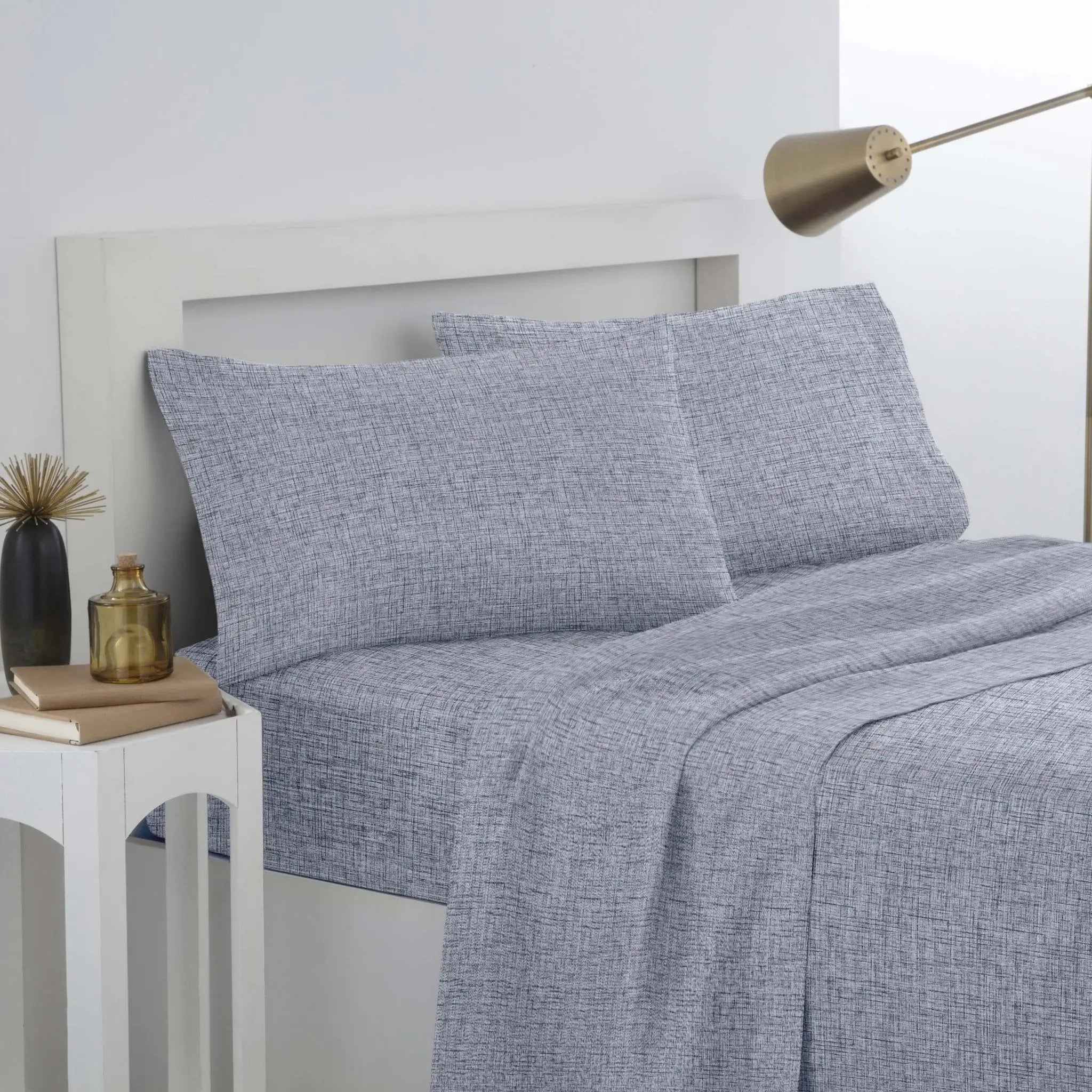 Gray textured bedding set on a bed.