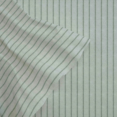 Textured fabric with wavy pattern and vertical stripes on a light green background