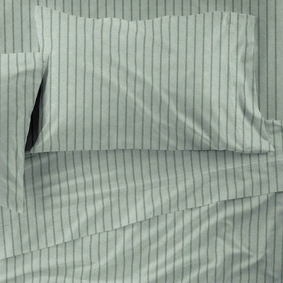 Light sage green bedding set with dark green vertical pinstripes, including a pillowcase and sheet, shown in a close-up flat-lay view.
