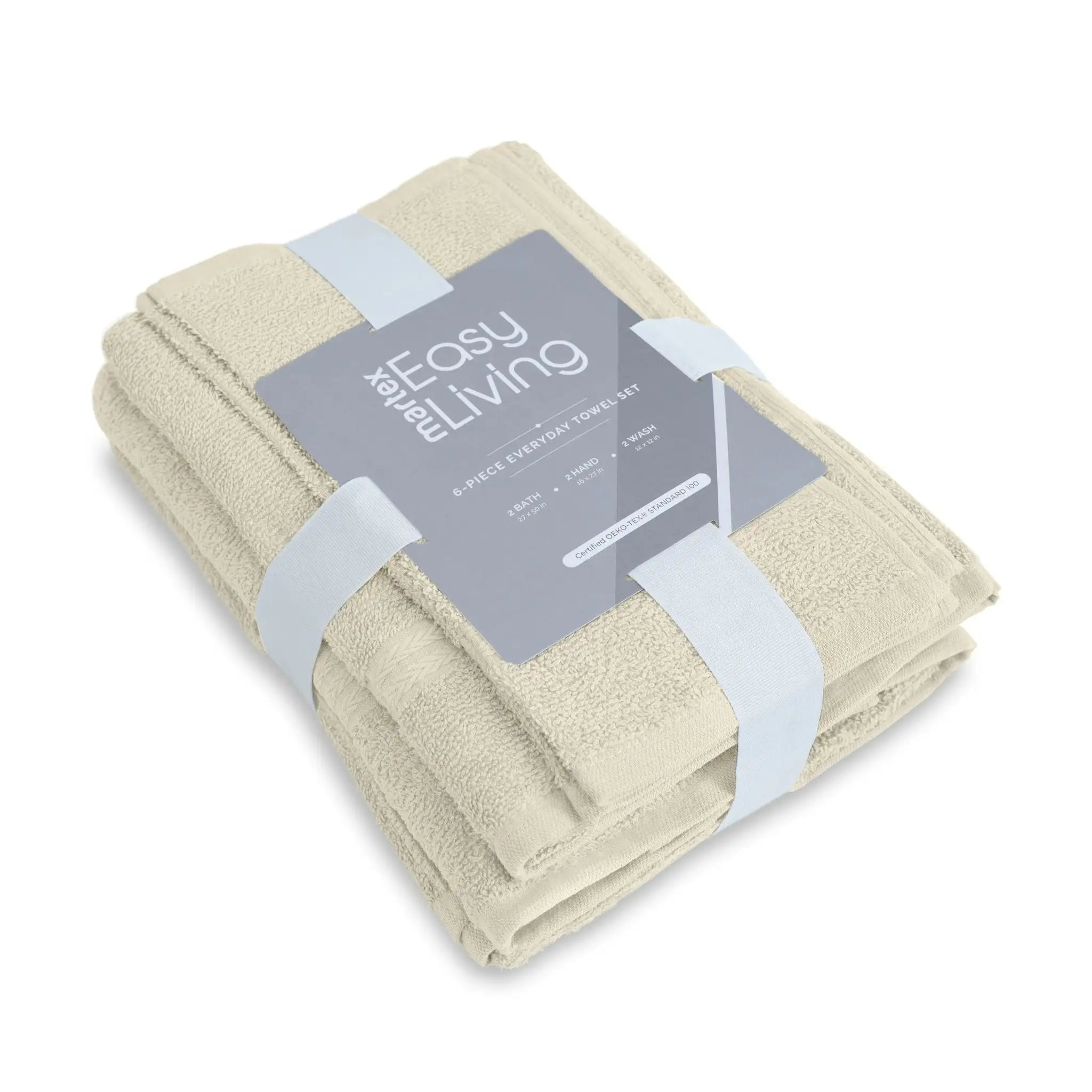 A folded set of six ivory towels wrapped in a clear plastic sleeve with a gray paper label that reads 'The Easy Living 6-Piece Everyday Essentials Set'.