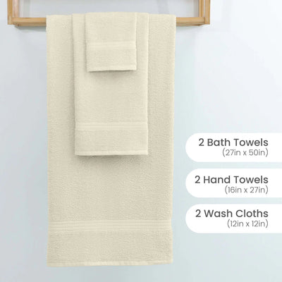 A set of three ivory towels hanging on a wooden rack against a light wall, with text labels on the right specifying sizes: 2 Bath Towels (27in x 50in), 2 Hand Towels (16in x 27in), and 2 Wash Cloths (12in x 12in).