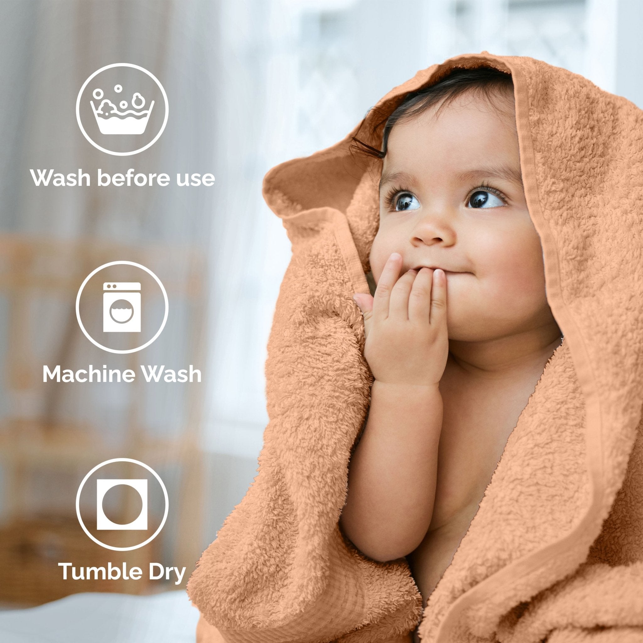 Child wrapped in a peach towel with washing instructions displayed