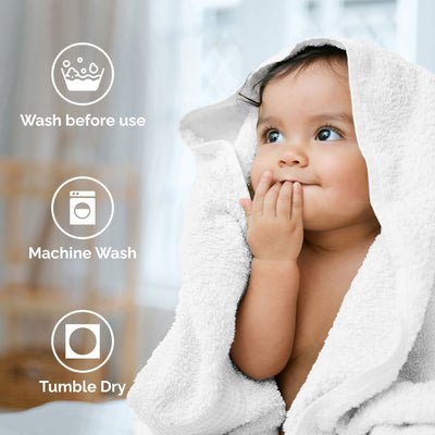 Child wrapped in a white towel with washing instructions displayed