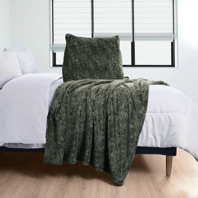 Green Pillow over a bed with white bedding in a room.