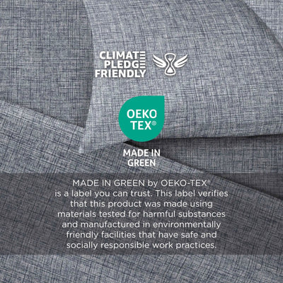 Close-up of gray textured fabric with printed certification logos and text including Climate Pledge Friendly, OEKO-TEX, and Made in Green.