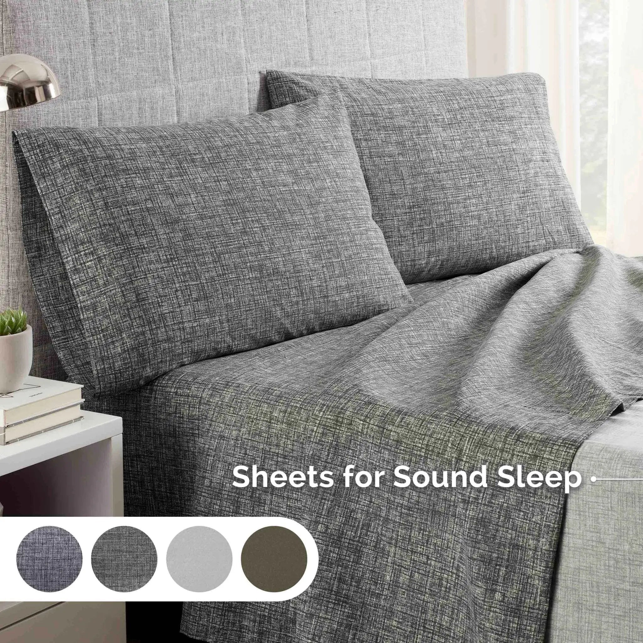 Gray textured sheets on a bed.