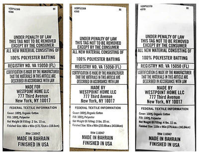 Three close-up views of the back of a polyester bath towel, showing printed text including 'UNDER PENALTY OF LAW', 'Made by Westpoint Home LLC', 'Made in Bahrain Finished in USA', and 'Federal Textile Information'.